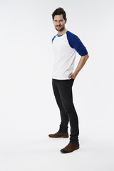 Casually dressed man in white studio