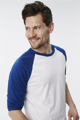 Smiling dude in white and blue top, looking away