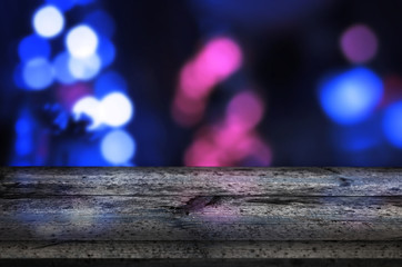 Board, table for product presentation. Blue bokeh city lights in background. Empty table with free space for text.