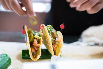Hand cook Maxican food, plate with taco, tortilla chips and tomato dip
