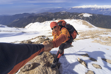 Winter hiking in the mountains with a backpack.