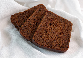 slices of rye bread on a white linen napkin