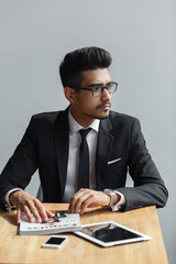 Young businessman sitting in cafe. rich entrepreneur waiting for a meeting with colleague