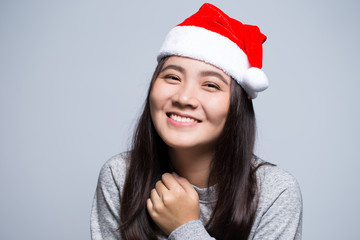 Happy woman wearing a santa hat on isolated background