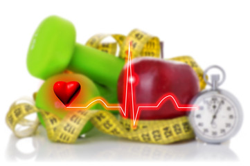 electrocardiogram on the background of dumbbells, red apple and measuring tape concept healthy lifestyle