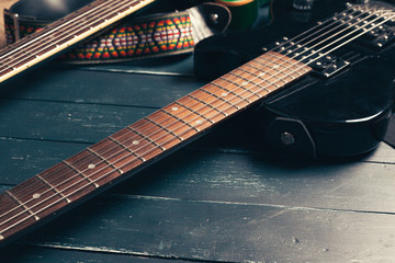 Electric guitar body and neck detail on wooden background