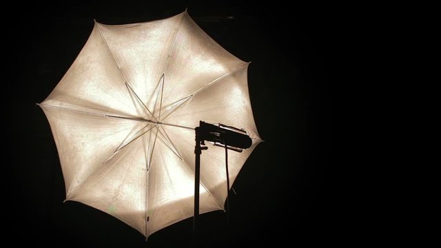 Studio light umbrella turns on