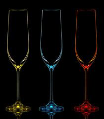 Silhouette of color champagne glass on black background.