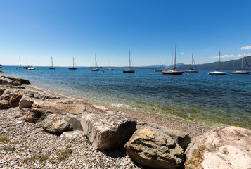 Fototapeta na wymiar Shore of the Lake Garda in the village of Torri del Benaco in Italy