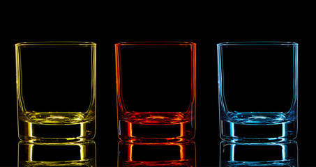 Silhouette of color strong liquor classic glass on black background