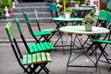 patio of a restaurant - green chairs and tables