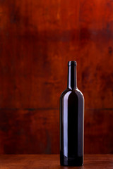 bottle of wine on dark red background