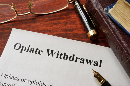 Opiate withdrawal written on a paper. Drugs addiction concept.