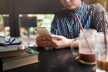 Woman using phone in cafe