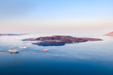 Greek islands in the morning fog, Santorini, Greece