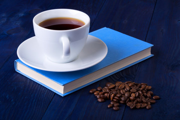 cup of coffee on a blue book