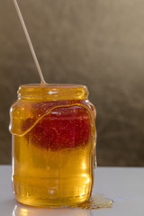 Apple sunken in a jar of honey 2