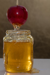 Jar of honey on color background with an apple 4