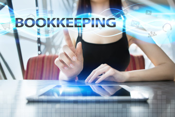 Woman is using tablet pc, pressing on virtual screen and selecting bookkeeping