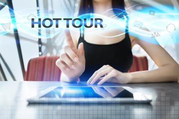 Woman is using tablet pc, pressing on virtual screen and selecting hot tour