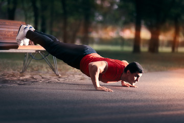 Fitness Man doing a Bench Press Up Outside