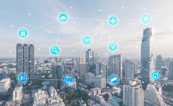 Icons with cityscape in background, internet of things conceptua