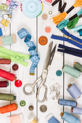 Old scissors, buttons, threads, measuring tape and sewing suppli - obrazy, fototapety, plakaty
