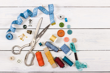 Old scissors, buttons, threads, measuring tape and sewing suppli