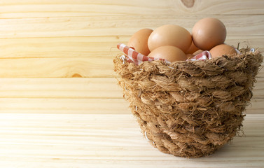 eggs in a basket wooden background