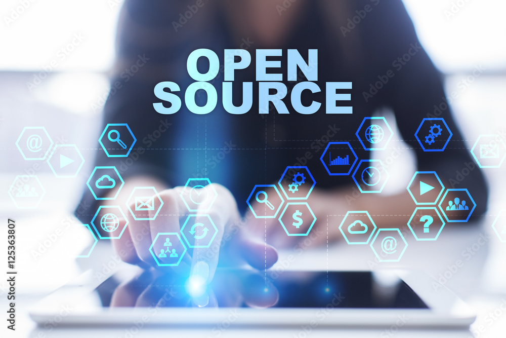Fototapete woman is using tablet pc, pressing on virtual screen and selecting open source