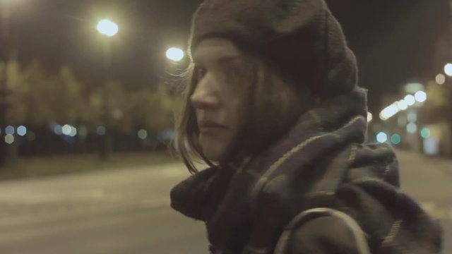 Young woman waiting taxi night city street hyperlapse cold tone shot
