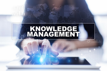 Woman is using tablet pc, pressing on virtual screen and selecting knowledge management