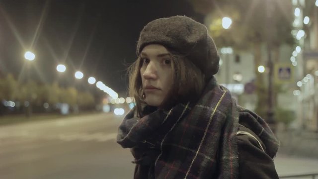 Young woman waiting taxi night city street hyperlapse cold tone shot