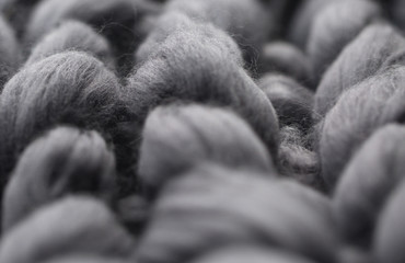 Close-up of knitted grey blanket, merino wool background