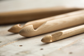 wooden knitting needles on wooden background