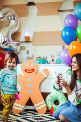 Picture of mom and son playing on the floor in room decorated fo