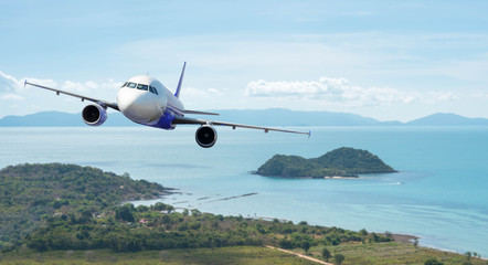 Airplane with beautiful ocean and island in background, explore