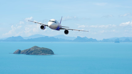 Airplane with beautiful ocean and island in background, explore