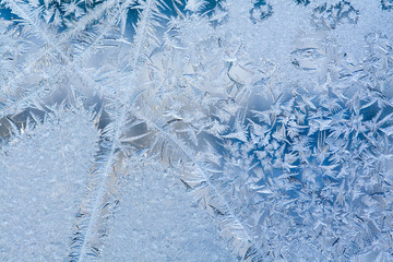 Ice flowers and frozen dirty window macro view. Frost texture pattern. Winter scene. soft focus photo
