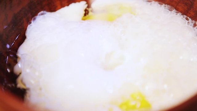 eggs with milk in a clay bowl