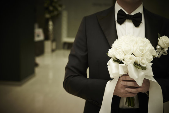 Groom Holding Wedding Bouquet