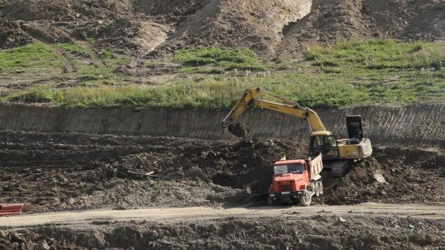 Truck and excavator working in quarry