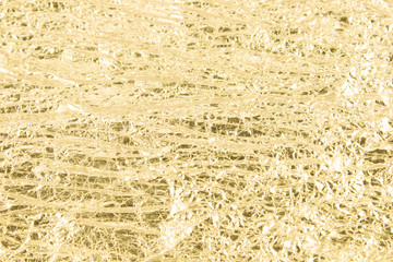 Gold wrinkled paper texture abstract background
