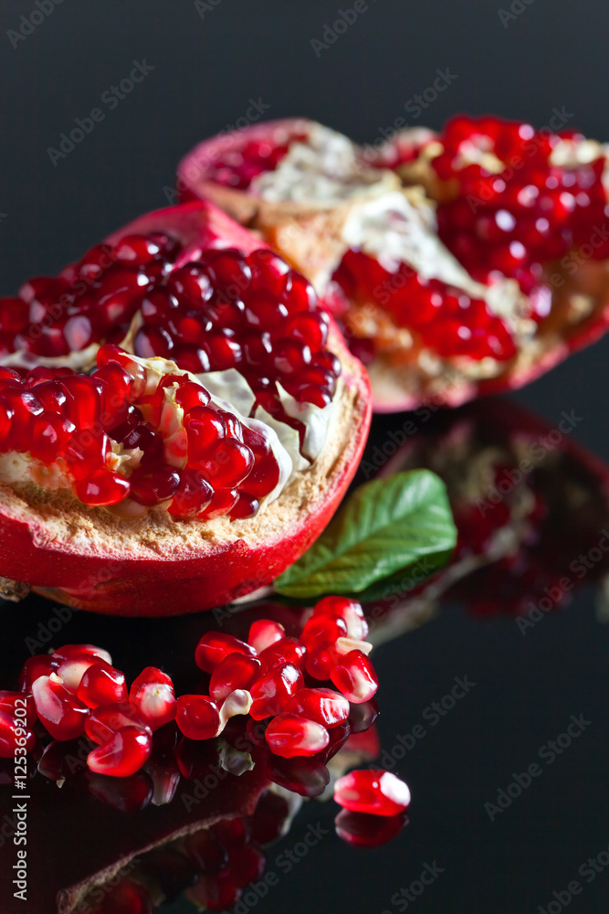 Wall mural broken ripe pomegranate with leaves