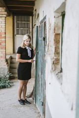 Spooky Blonde woman near old door 