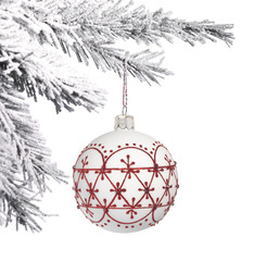 Bauble and snow covered Christmas tree