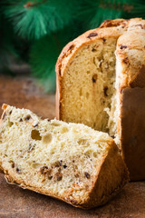 Christmas cake panettone and Christmas tree on rustic background

