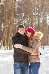 Fototapeta na wymiar Happy Young Couple in Winter Park having fun. Family Outdoors. love