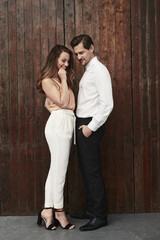 Fashionista couple in studio, smiling