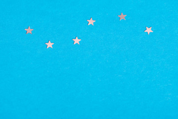 Fototapeta na wymiar Frame of scatters little silver stars on blue background.